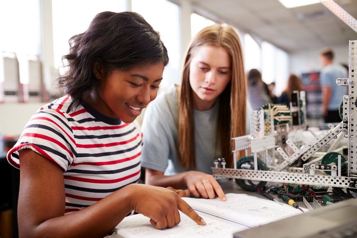 Two,Female,College,Students,Building,Machine,In,Science,Robotics,Or